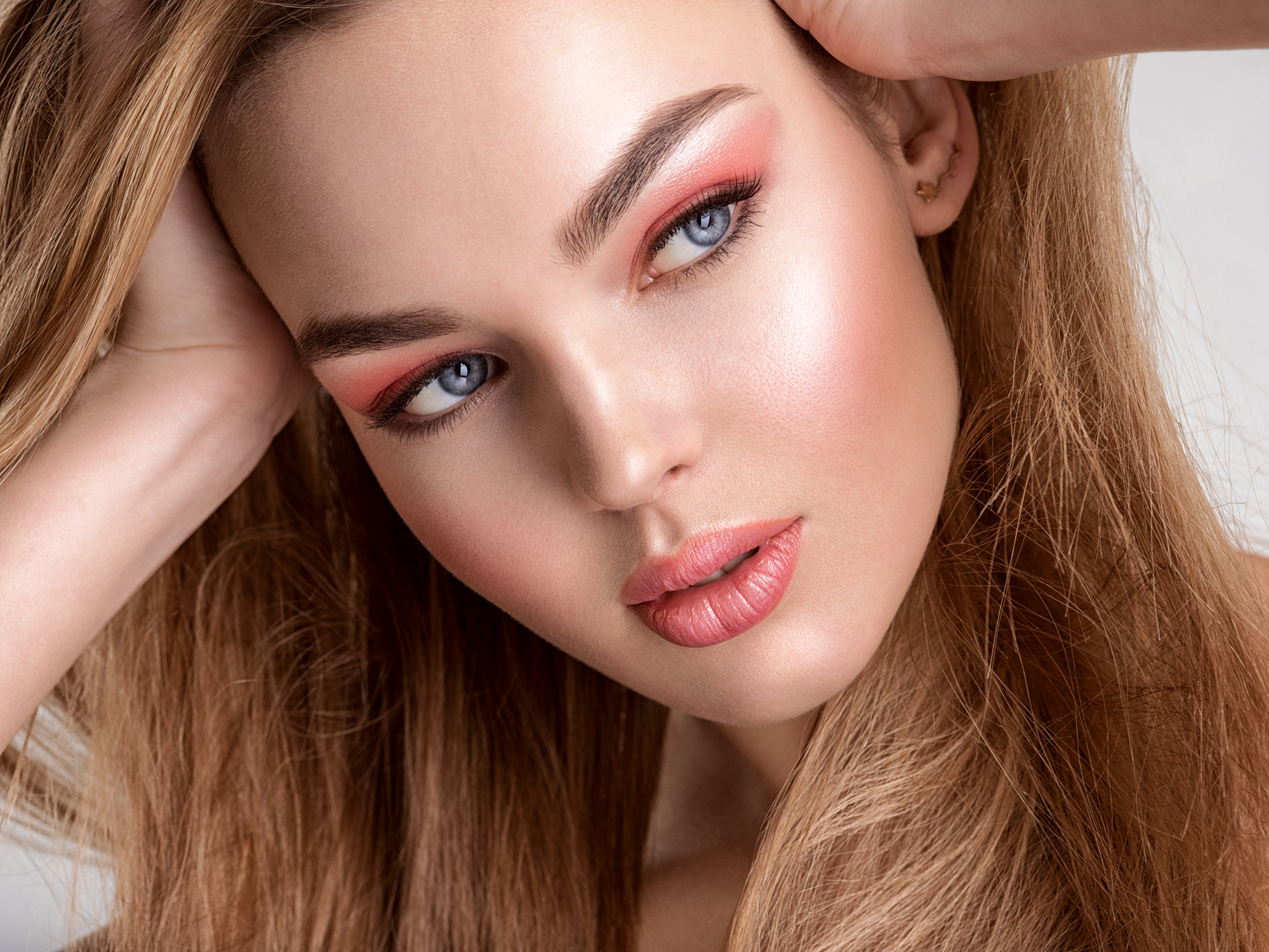 Portrait of a Face Model with Coral Makeup